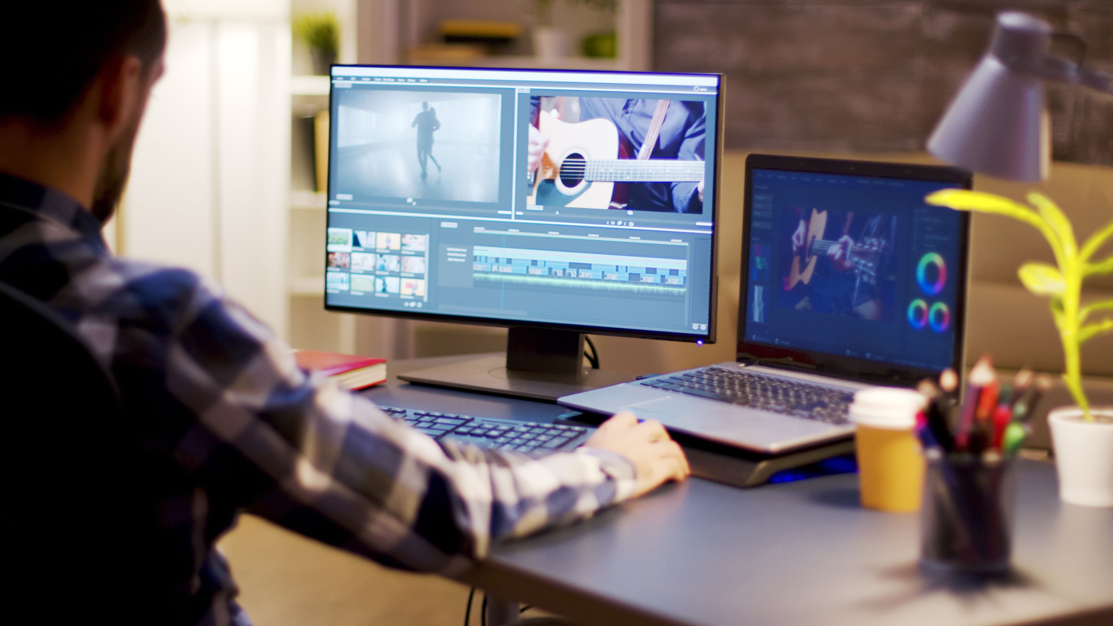 A multimedia editor working at a dual-monitor setup, editing video and color grading. This image showcases creativity and attention to detail, ideal for inspiring visually compelling landing page designs.