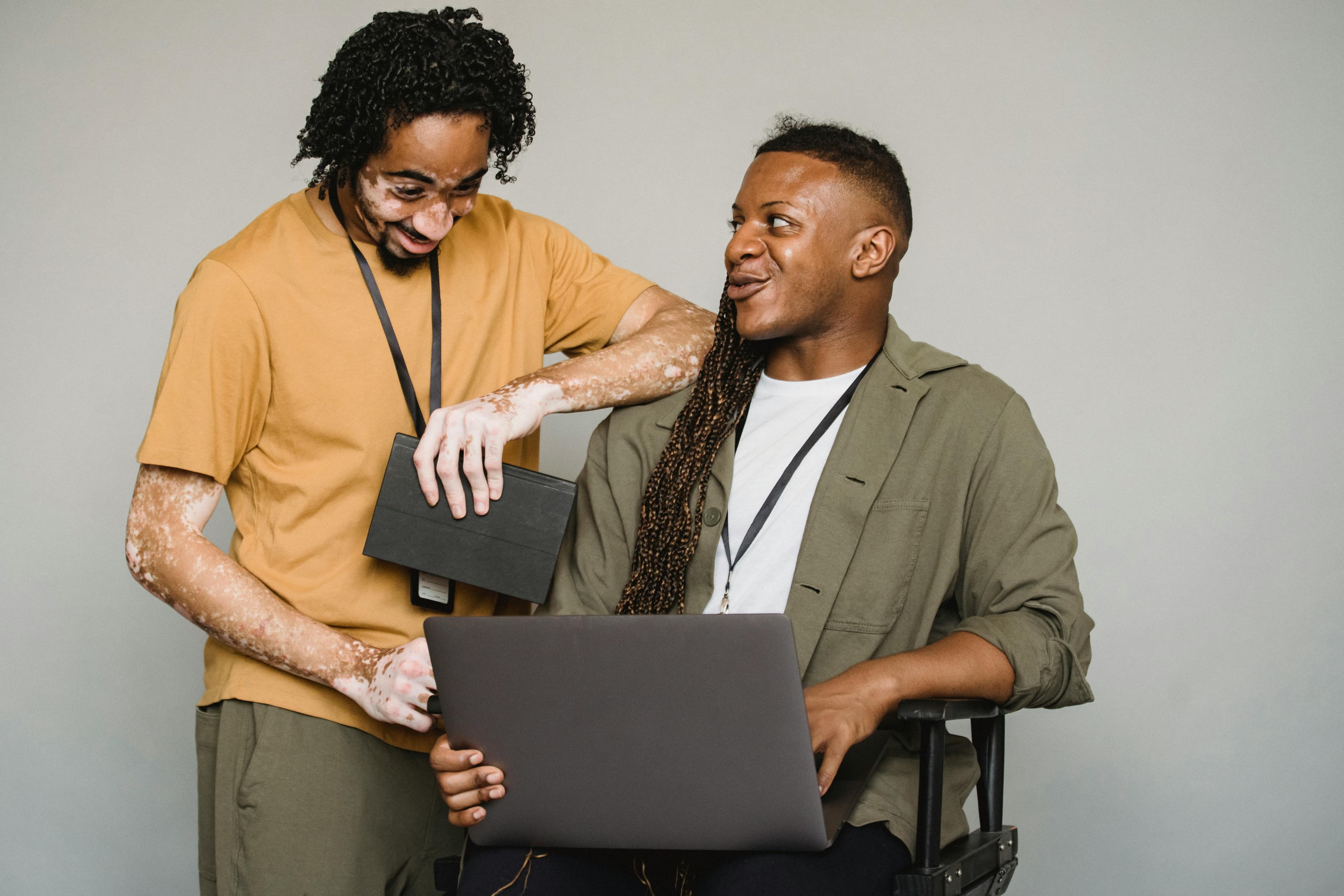 Two colleagues collaborating and smiling while looking at a laptop, representing conversion optimization services.