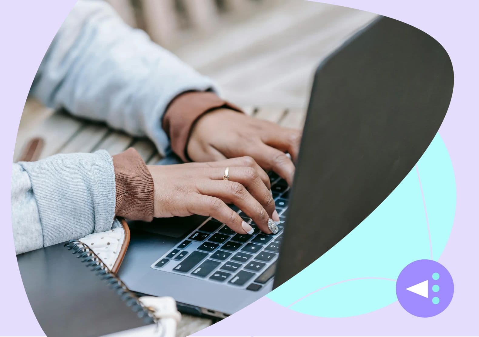 A close-up of hands typing on a laptop, with a notebook and pen nearby, symbolizing content creation and planning. This image is ideal for an influencer marketing hub, showcasing the tools and effort behind crafting engaging online content.