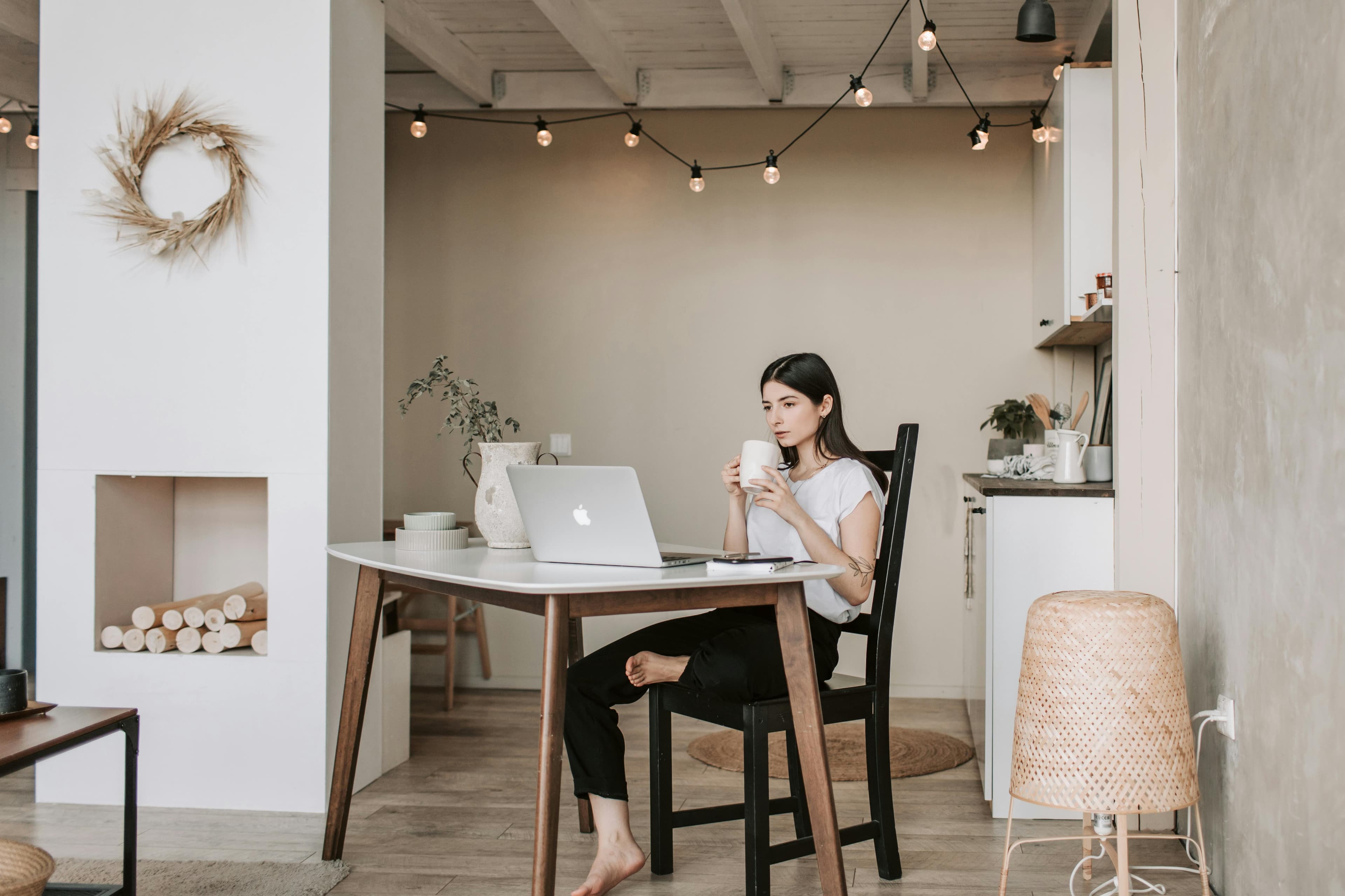  A woman working on her laptop. This image is ideal for promoting lead management software that enhances productivity and organization in a home office setting.