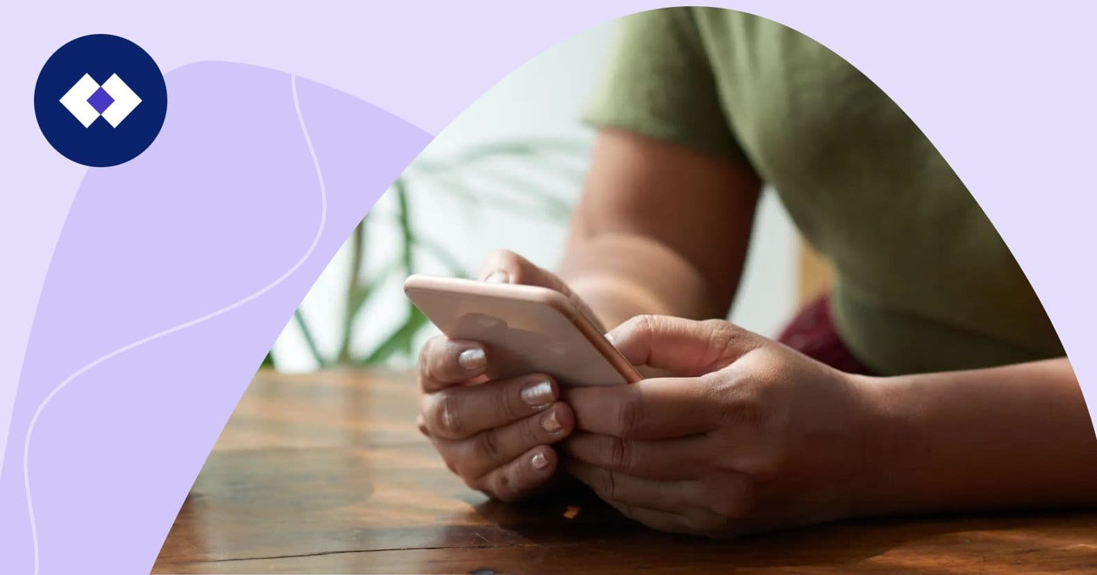 A person sitting at a table, holding a smartphone and a coffee cup nearby, with a plant in the background. This scene represents "small business marketing consultants" staying connected with clients and partners through digital communication and mobile devices.