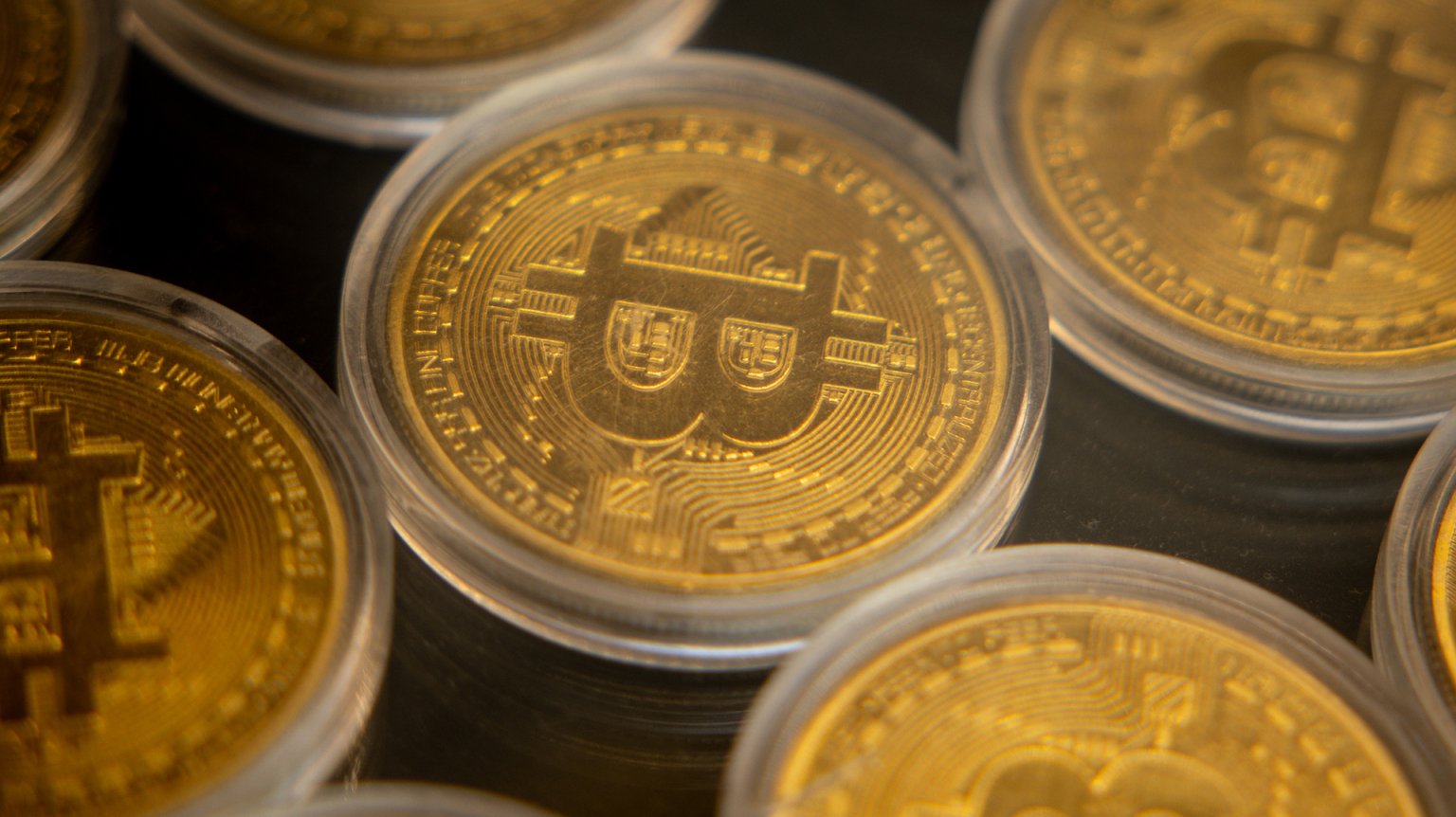 Gold coins with the Bitcoin "B" stamped on them.