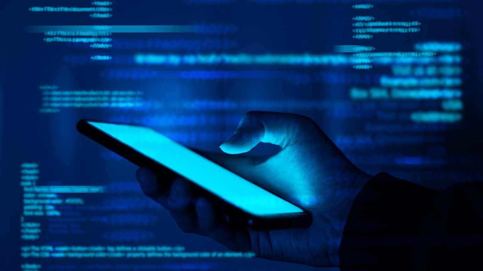 A hand holds a phone in a glowing blue environment filled with floating lines of computer code. 