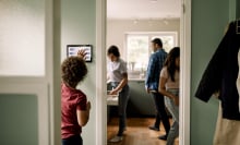 a family inside of their home uses smart home devices