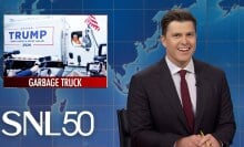 colin jost joking on SNL set with graphic about trump's gabage truck