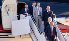 Elon Musk and members of Donald Trump's team walk out of a private plane. 