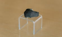 A chunk of the Lafayette meteorite on a clear stand