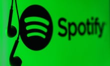 the spotify logo with headphones dangling next to it