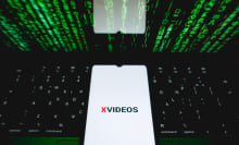 The XVideos logo is being displayed on a smartphone screen