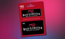 $50 red lobster gift card angled on a pink and black background