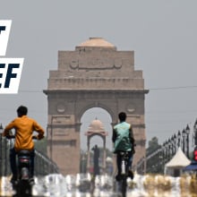 A still image showing a main road in New Delhi in the heat. Caption reads: "heat relief"