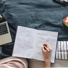 Notebook and laptop on bed