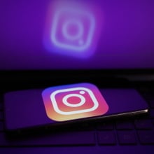 A glowing phone screen shows the Instagram logo. 