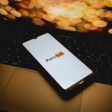 The Pornhub logo is being displayed on a smartphone screen