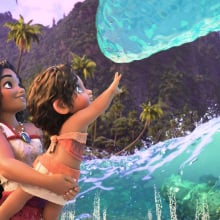 A still from "Moana 2" in which Moana holds her little sister up to a friendly wave in greeting.