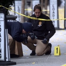 Police at the scene of Brian Thompson's murder.