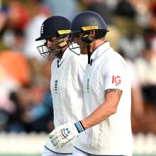 Joe Root of England and Ben Stokes of England walk off