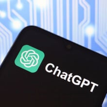 The ChatGPT logo appears on the screen of a smartphone