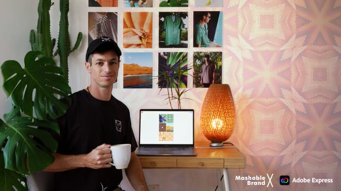 Keefer Charneau holding mug in front of home office setup.