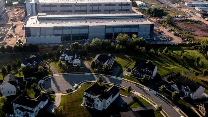 An aerial shot of an Amazon data center, right next to a residential neighborhood. 