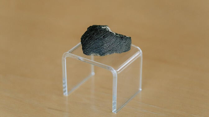 A chunk of the Lafayette meteorite on a clear stand