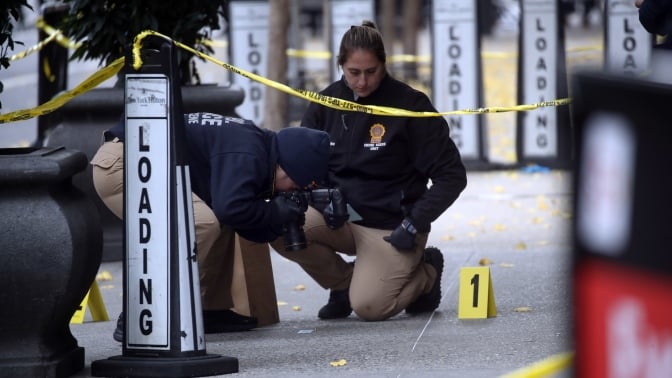 Police at the scene of Brian Thompson's murder.