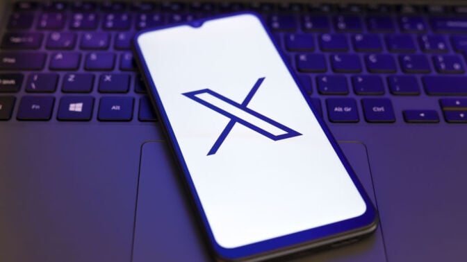 X logo on phone screen