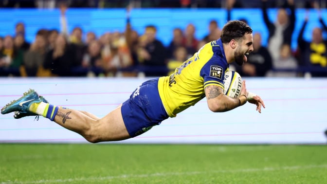 Clermont's French wing Lucas Tauzin dives across the line