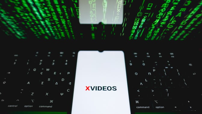 The XVideos logo is being displayed on a smartphone screen