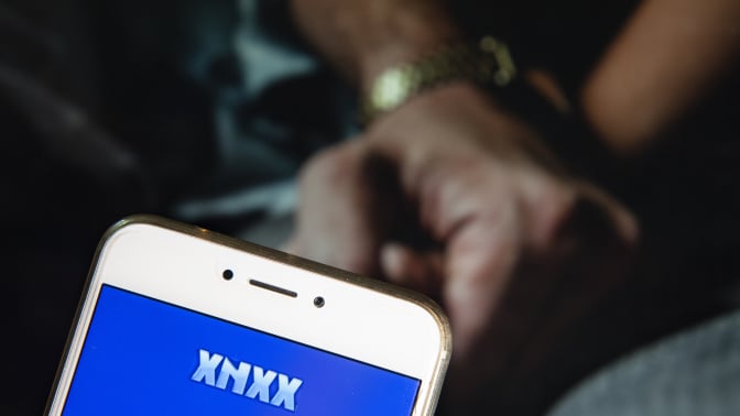 In this photo illustration, the Pornographic video sharing website Xnxx logo is seen displayed on an Android mobile device