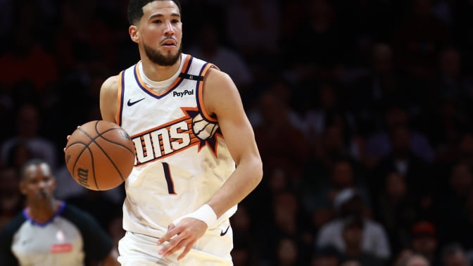 Devin Booker #1 of the Phoenix Suns controls the ball against the Miami Heat during the second half at Kaseya Center on December 07, 2024 in Miami, Florida.