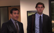 A screenshot of two men, Steve Carell as Michael Scott and John Krasinski as Jim Halpert, from an episode of "The Office." One of the men, Carell, is soaking wet from an accidental fall in a koi pond.