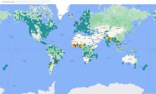 A map of the world with green, yellow, and red dots indicating flood areas.