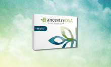 An AncestryDNA kit in front of a green and blue background. 