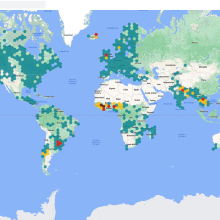 A map of the world with green, yellow, and red dots indicating flood areas.