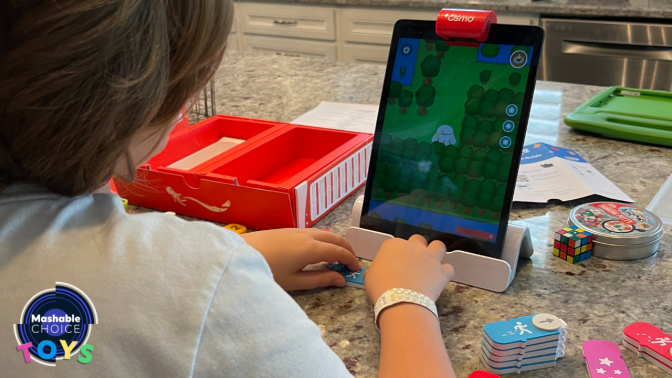 kid playing a coding game on an iPad