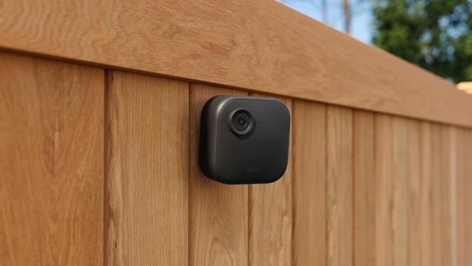 Blink outdoor camera on a wooden fence 